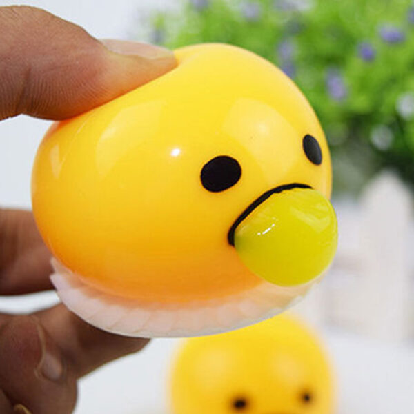 divertit vòmit d'ou groc que exprimeix les joguines complicades per reduir l'estrès